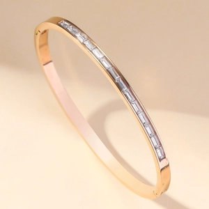 Rose gold stainless steel bracelet with baguette-cut zircon inlay shown from a 45-degree angle
