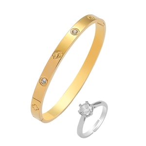 Gold-toned four-leaf flower bangle with crystals and classic silver-toned solitaire ring