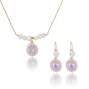 Golden necklace and earrings set with white pearls and oval pink zircon pendants