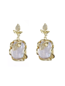 Detailed close-up of leaf-shaped gold earrings with lavender baroque pearls and zircons