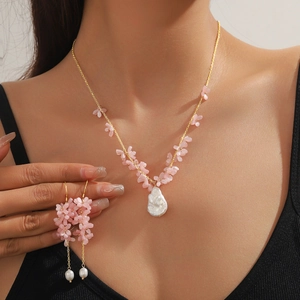 Baroque pearl necklace and earring set with pink flowers on a female model