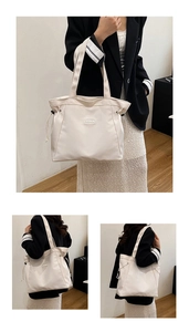 Detail view of cream tote bag with side drawstrings and fashion woven label