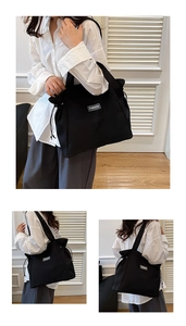 Detail of black canvas tote bag showing the unique drawstring closure and fashion label