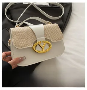 Detailed macro of vintage saddle bag with cream leather and woven texture and gold clasp