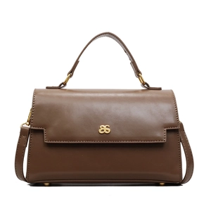 Deep coffee vintage faux leather shoulder bag with a gold bow buckle on white background