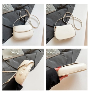 Detailed views of a minimalist white semi-circle crossbody saddle bag with smooth leather texture