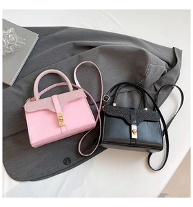 Detail of pink and black mini crossbody bags with glitter texture and gold metal turn lock