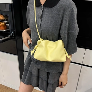 Pale yellow pleated cloud bucket bag in soft PU leather with side knot drawstrings