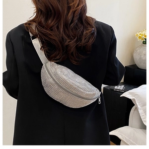 Silver rhinestone waist bag with adjustable strap worn over a black blazer for women