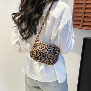 Summer leopard print saddle bag for women with adjustable strap shown on model shoulder