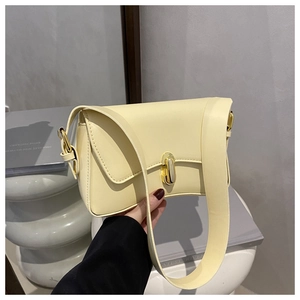 Detail of light yellow square crossbody bag with gold metallic twist lock and wide strap