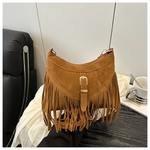 Close-up of brown suede hobo bag featuring retro metal buckle and long fringe details