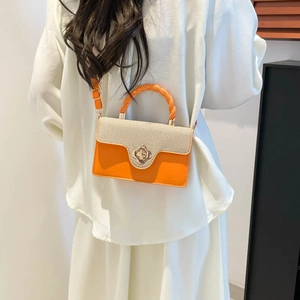 Chic orange and canvas underarm bag with flower buckle and woven handle for women
