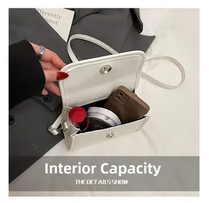Internal view of a white PU leather handbag showing storage space for phone and makeup