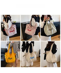 Detailed view showing multi-color casual canvas tote bags in pink, green, and yellow