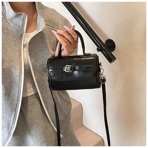Polished black patent leather mini bag with silver buckle and detachable shoulder strap