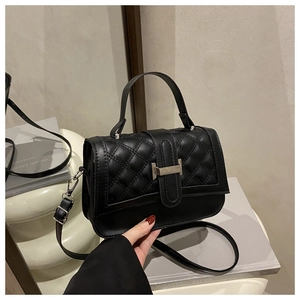 Detailed close-up of a black quilted PU leather crossbody bag with a gold metal T-lock