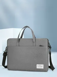 Detail of grey laptop briefcase featuring durable fabric texture and reinforced handles