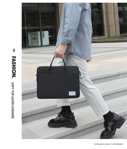 Business professional carrying a sleek black leather laptop briefcase in an outdoor setting