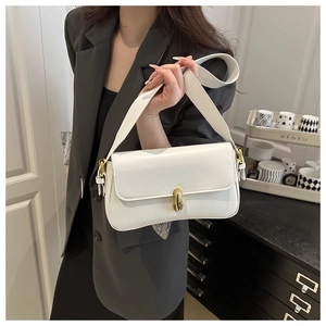 Detailed shot of white French vintage underarm bag with gold oval buckle and wide strap