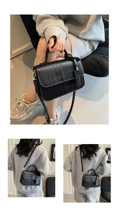 Detail view of black patchwork crossbody bag with quilted texture and fashion tag
