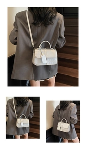 Detail view of silver grey crossbody bag featuring rhombus quilted pattern and top handle