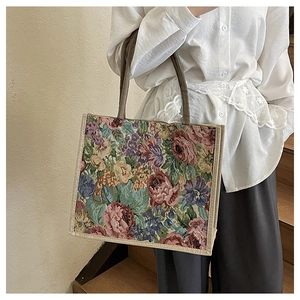Detail of floral woven linen tote bag featuring retro oil painting texture and rope handles