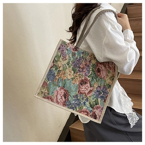 Floral tapestry tote bag with vintage rose patterns shown as a shoulder carry style