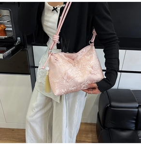 Detail of pink lace embroidery shoulder bag with 3D butterfly patterns and long tassels