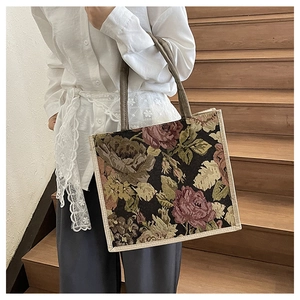 Close-up of vintage floral tapestry texture and reinforced woven edges on the large tote bag