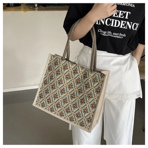 Detailed view of vintage jacquard floral tote bag with sturdy woven brown handles