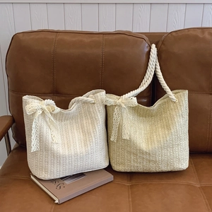 Fashionable straw tote bags in beige and khaki with rope handles and lace bows