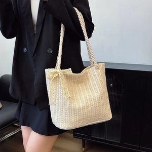 Minimalist cream woven straw tote bag with large capacity and yellow lace bow detail