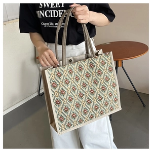Detailed close-up of floral tapestry tote bag with canvas straps and magnetic closure