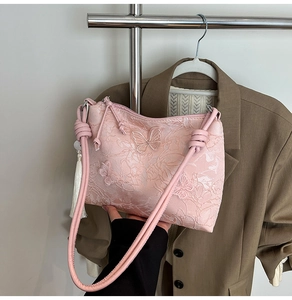 Detailed pink lace handbag with 3D butterfly embroidery and elegant white fringe tassel