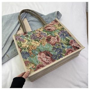 Detail of vintage floral jacquard pattern and linen fabric on a large tote bag