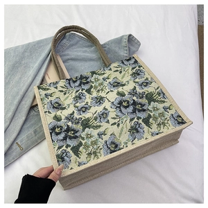 Detail of floral tapestry linen tote bag with sturdy jute side and round handle