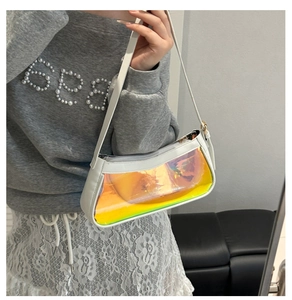 Close-up of holographic PVC window and white leather detail on the shoulder bag
