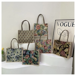 Selection of floral linen tote bags with thick rope handles on a stylish display