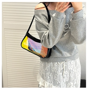 Iridescent crescent underarm bag with black trim shown on model against white background