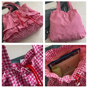 Detail view of pink checkered tote bag showing ruffled edges and spacious inner capacity