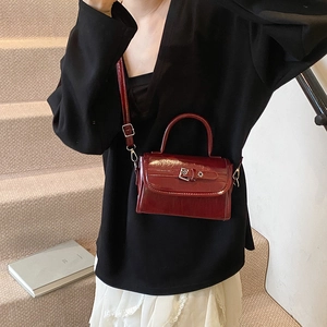 Glossy burgundy patent leather square handbag with top handle and shoulder strap