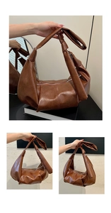 Detail of retro brown hobo bag with oily leather texture and knot shoulder strap