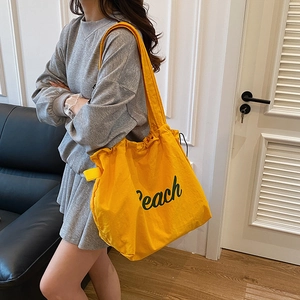 Bright yellow canvas tote bag with green Peach print for casual school and daily use