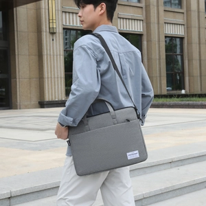 Grey padded canvas laptop bag with adjustable shoulder strap and shockproof design
