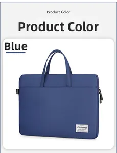 Detail of dark blue laptop bag showing double handles, side fashion label and nylon texture