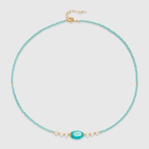 Detail of beaded necklace featuring turquoise stone, freshwater pearls and gold clasp