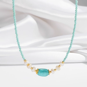 Macro detail of turquoise pendant necklace with freshwater pearls and blue beads