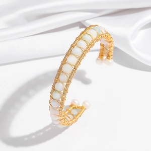 Minimalist gold wire-wrapped bangle featuring elegant natural pearls and green stones