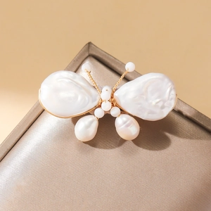 Elegant butterfly brooch with baroque freshwater pearls and gold-plated wire detailing
